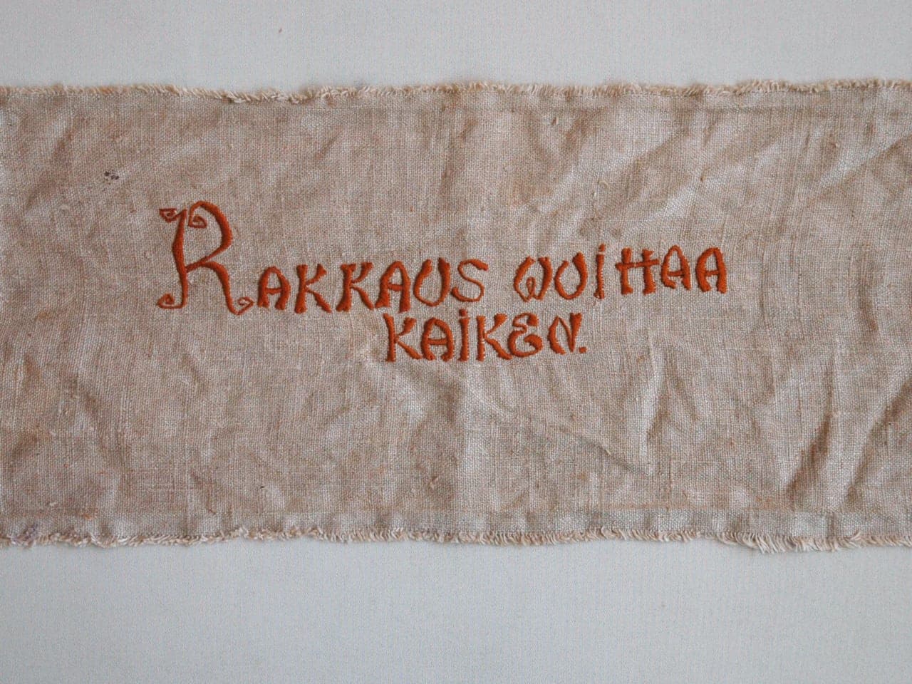 Embroidered wall hanging “Love Conquers All”